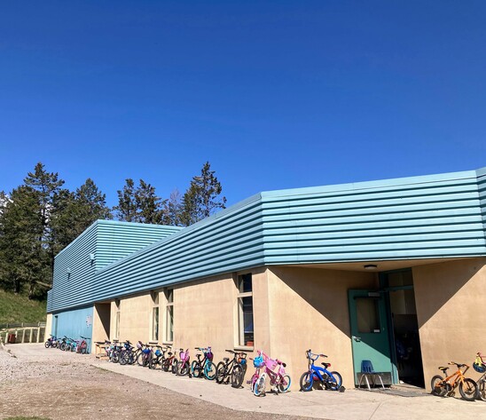 Bikes along the wall of the school